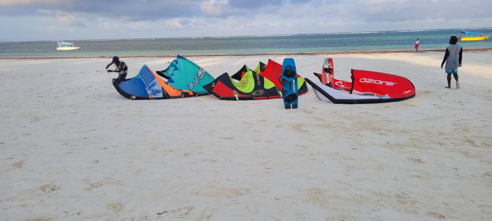 Kites laid out and being pumped up on the white sand of Diani Beach