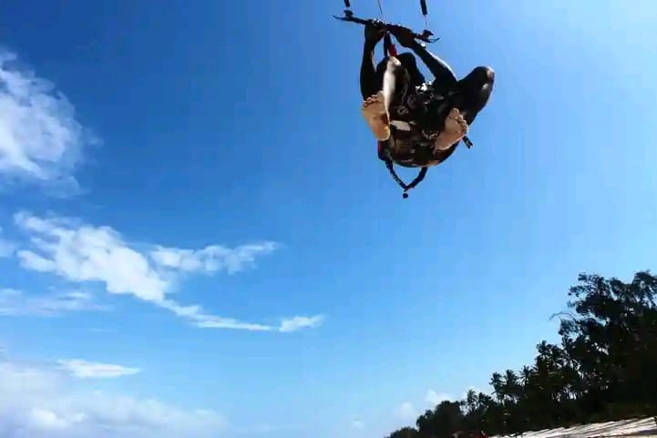 Kite looping high in a clear blue sky above Diani Beach
